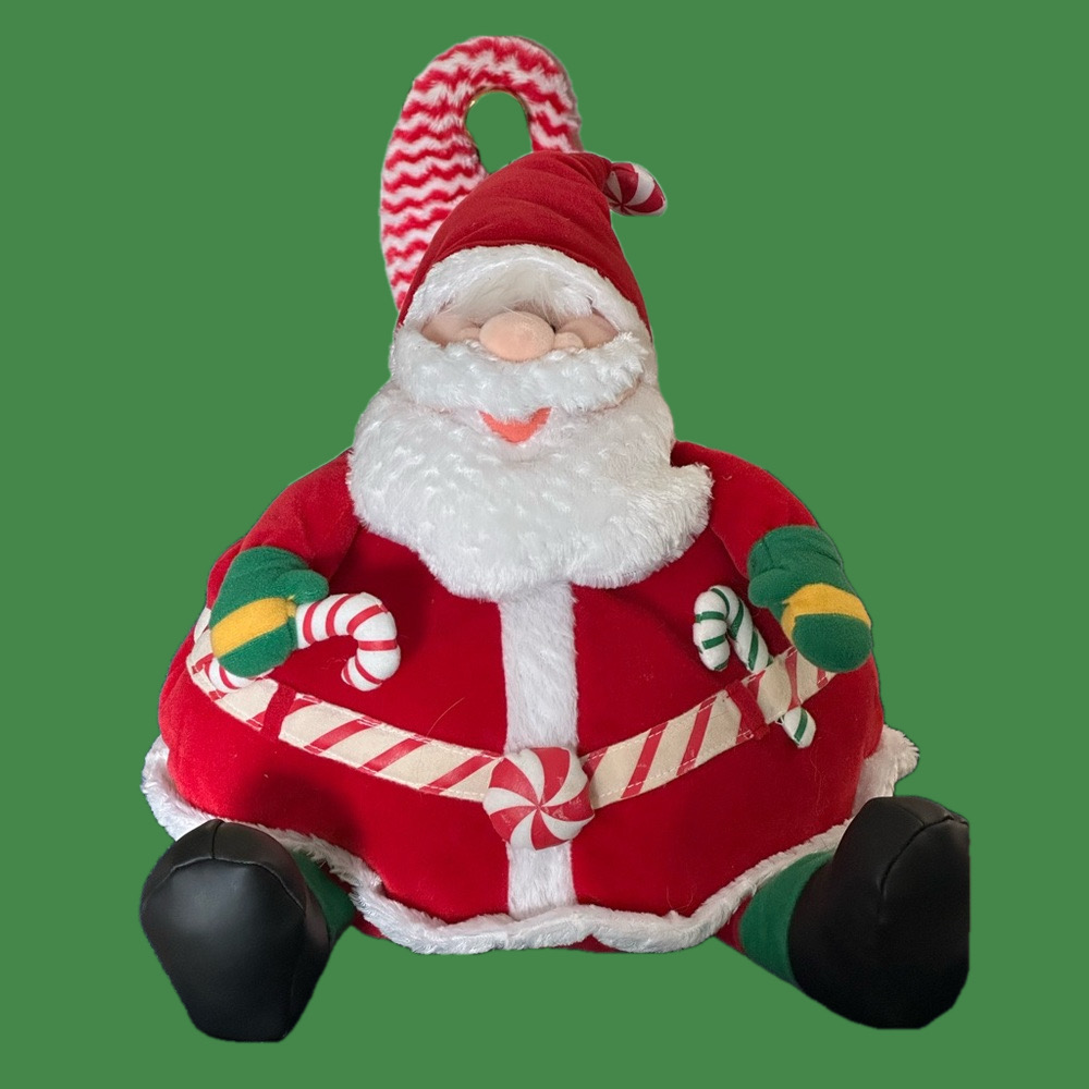 Jolly round stuffed Santa holds a candy cane with an extra in his belt